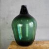 Large antique green blown glass demijohn (France, c.1900)