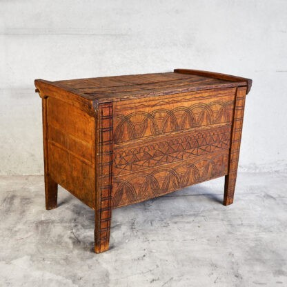 Antique solid wood trunk made of pine wood with woodcarving drawings (c. 1920).